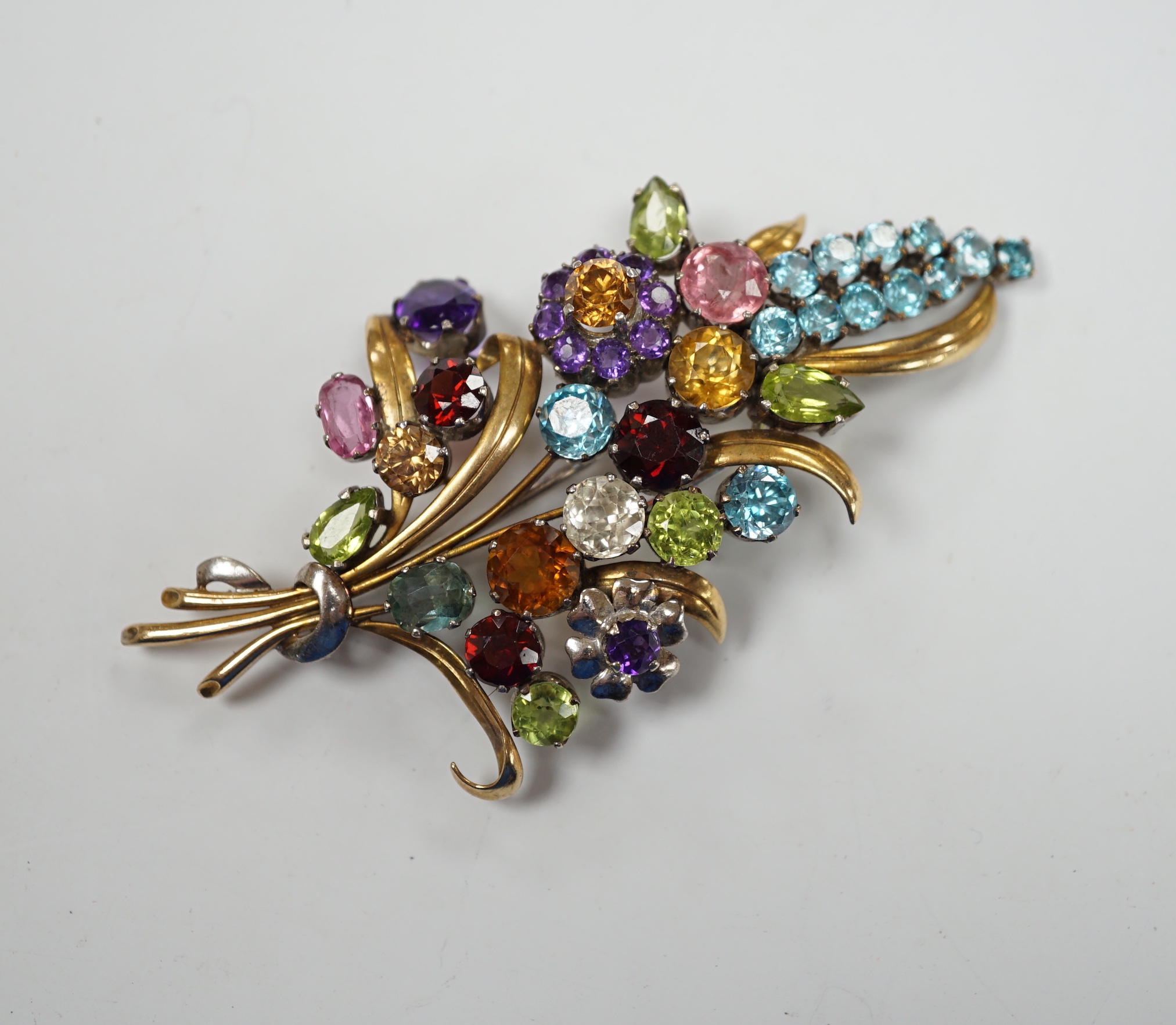 A 9ct and multi gem set floral spray brooch, including zircons, tourmaline and amethyst, by Cropp & Farr, 85mm gross weight 23.1 grams